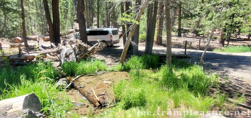 photo showing van and stream at gated entrance