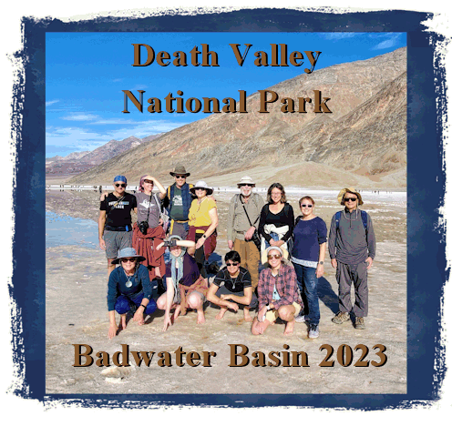 image of a group of people standing on a plateau with a pool of water and mountains in the background