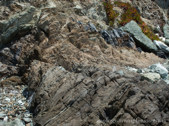 layered rocks laying at an angle