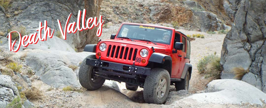 Photo showing a Jeep driving on difficult terrain.
